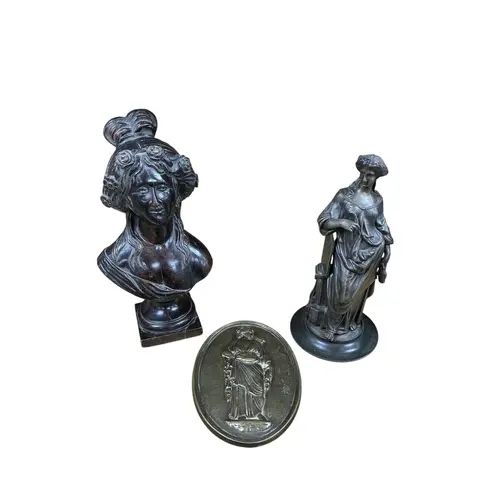 A bronze bust of a classical maiden, together with an oval b...