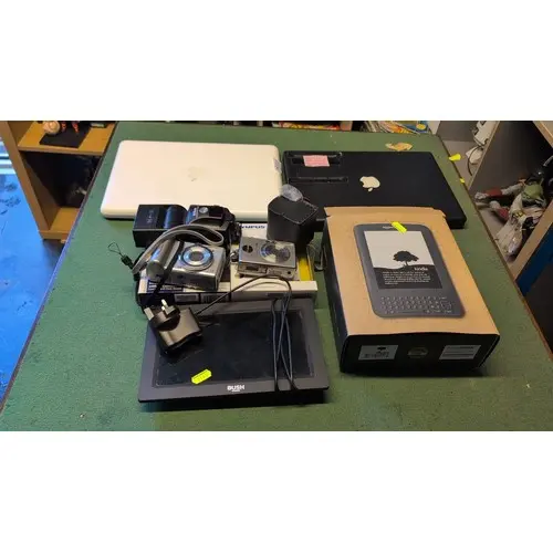 A group of consumer electronics including Apple MacBook A118...