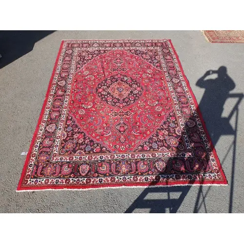 A Persian style Carpet on red ground, with multi borders and...