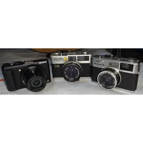 A Sony Cyber-shot Exmor R Sony Lens G camera, a vintage Olym...