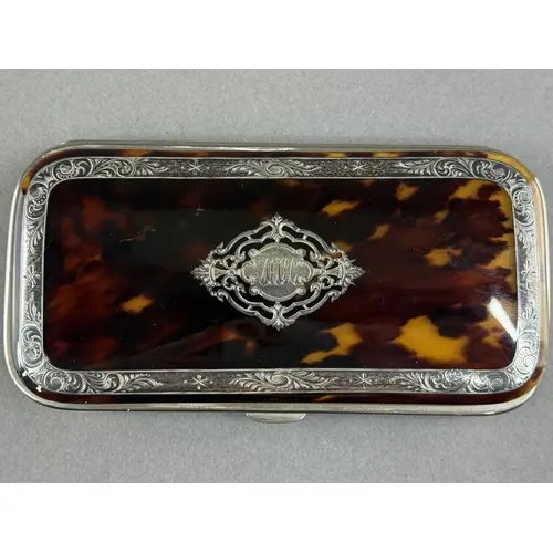 Decorative Arts: a late 19th century white metal inlaid tort...