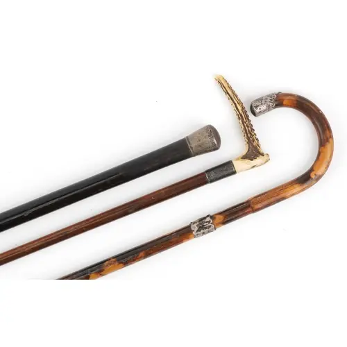 Three antique walking sticks with silver mounts, including a...
