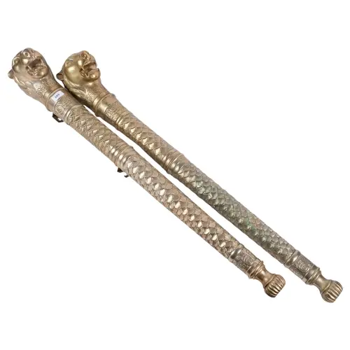 A pair of large ornate pressed metal ceremonial staffs (Indi...