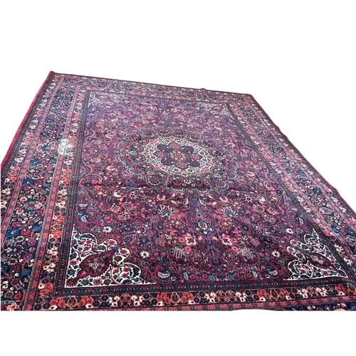 A red ground meshed carpet, 418 x 318cm