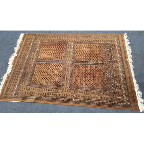 AN ORANGE / RED GROUND RECTANGULAR WOOLLEN RUG, with repeati...