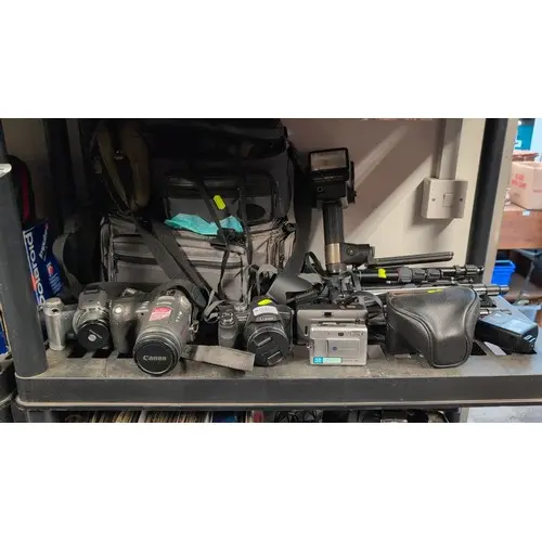 A group of digital cameras by Canon, Panasonic Lumix and Kon...