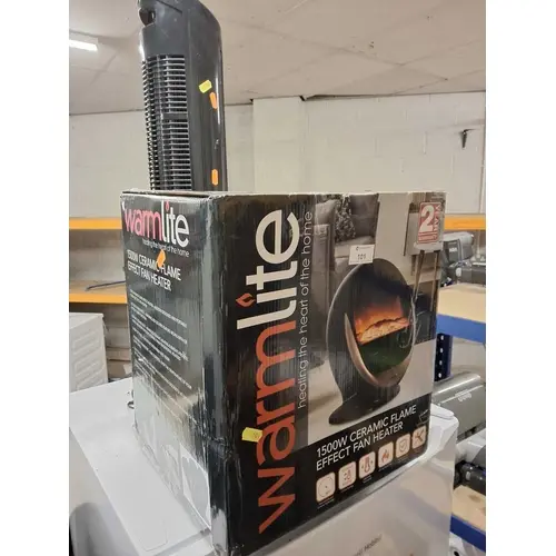 A WARMLITE FLAME EFFECT HEATER, with original box and a More...