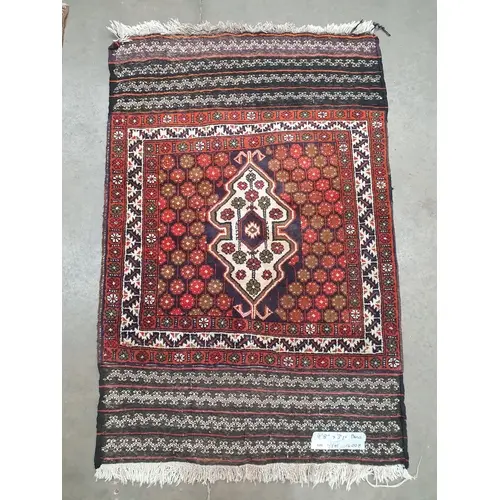 A Turkomen style Rug on blue and red ground, with stylised b...