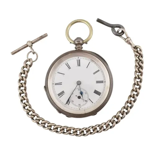 A Victorian hallmarked silver pocket watch on a silver watch...