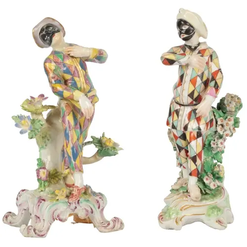 A Bow porcelain figure of a Harlequin, along with a Derby po...