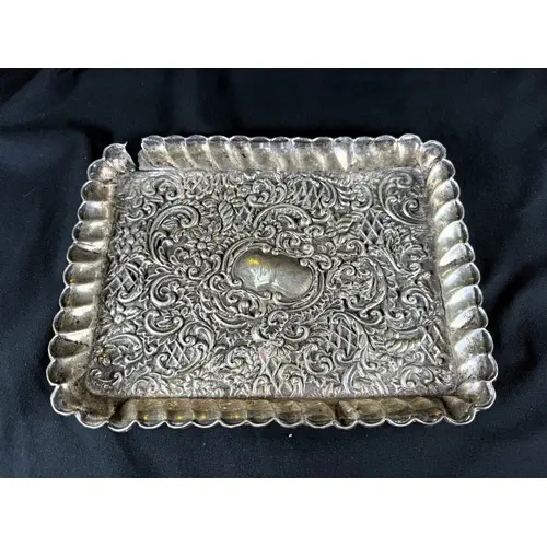 A hall marked silver heavily embossed tray with scolloped ed...