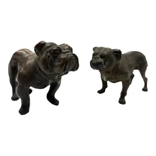 Two Austrian style bronze bulldogs, one with partial cold pa...