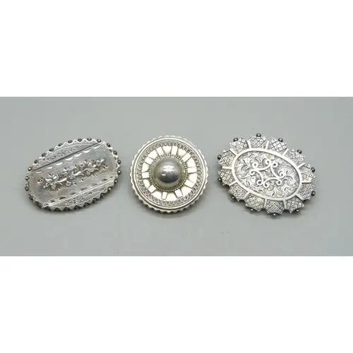 Victorian brooches - Two white metal examples and a silver e...