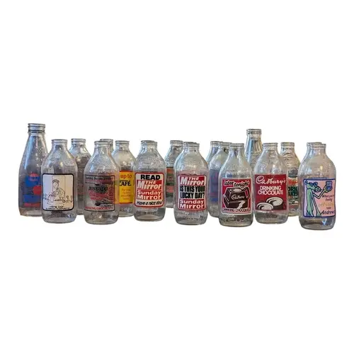 A colection of vintage 20th century glass milk bottles. The ...
