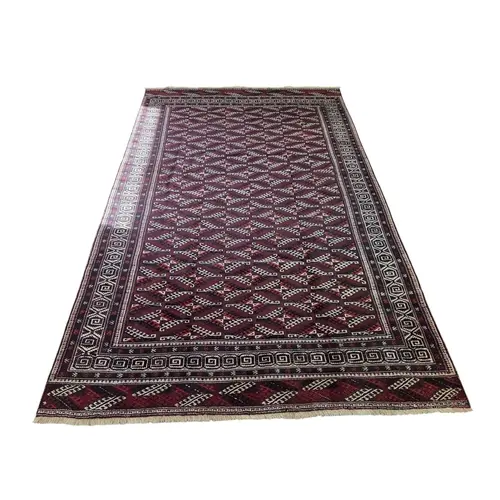 A deep Red ground full pile wool hand woven Turkman Carpet w...