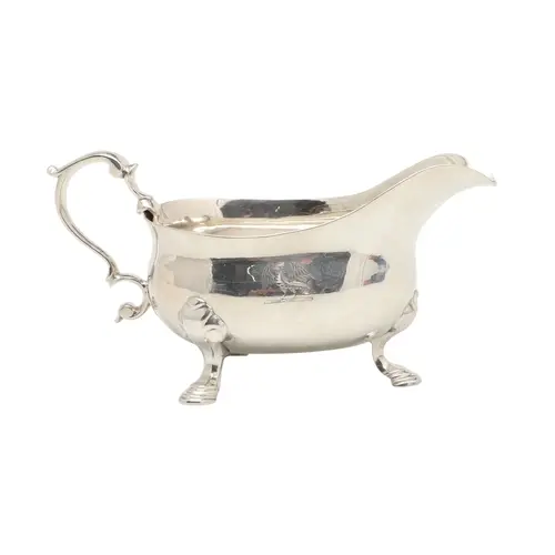 A GEORGE II SMALL SILVER SAUCE BOAT. Engraved with a crest, ...