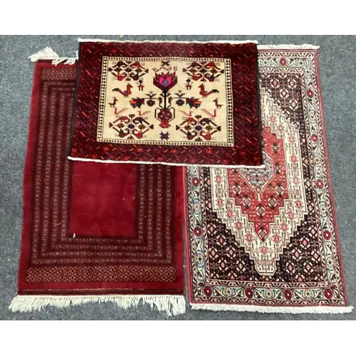 A Persian style rug, red brown and cream coloured 71x136cm;...