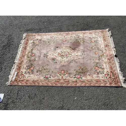 A Chinese style Rug with floral border and central floral mo...