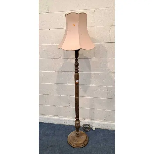 A HARDWOOD STANDARD LAMP, with foliate carved details, on a ...