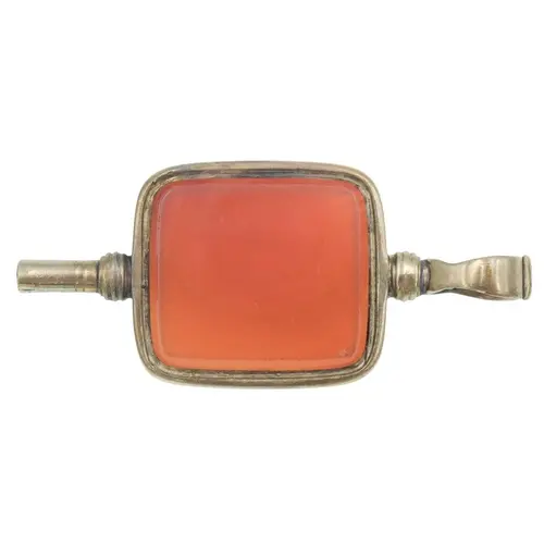A gold and carnelian pocket watch winder. Dimensions are 4cm...