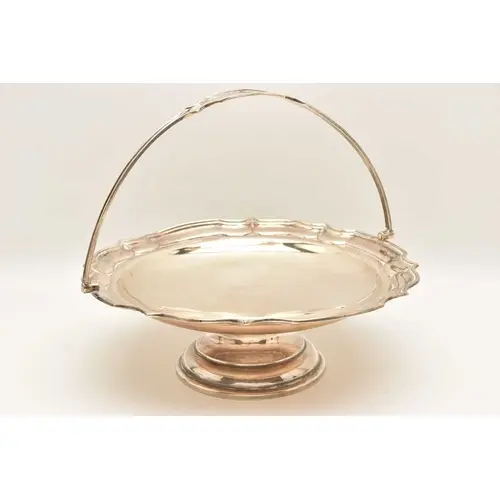 A GEORGE V SILVER PEDESTAL BASKET, of a circular wavy form f...