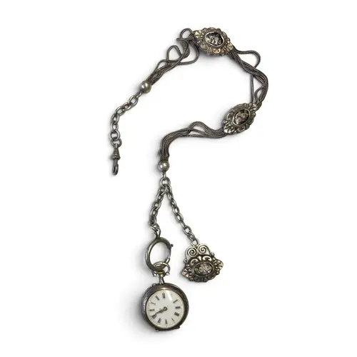 A Silver pocket watch with a silver chain, featuring silver ...