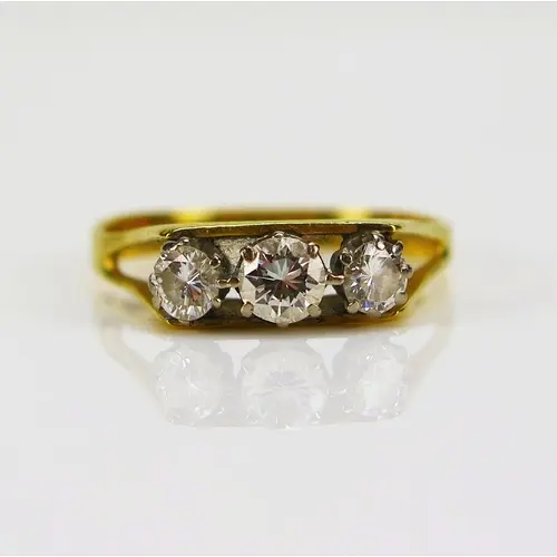 A three stone brilliant round cut diamond ring in an 18ct ye...