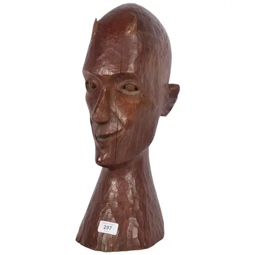 A carved textured wood sculpture, bust of horned figure, H46...
