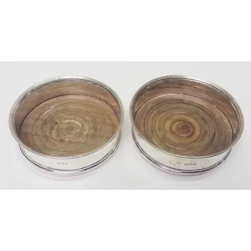 A pair of silver and hardwood coasters, 20th cent. A/F dents...