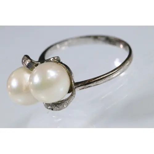 14ct white gold and cultured pearl ring. The ring being set ...