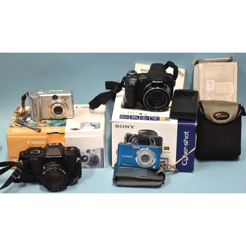 A Pentax P3 35mm SLR camera, a Canon PowerShot A95 (boxed), ...