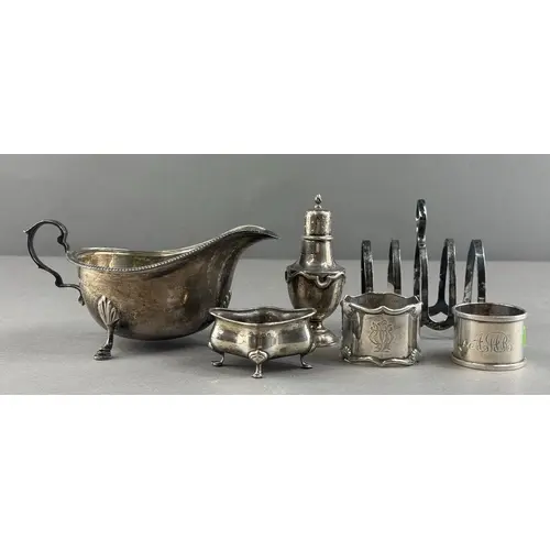Silver: a sauceboat with gadrooned rim and standing upon thr...