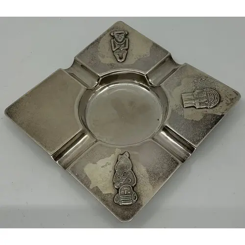 A South American silver ashtray decorated with Chilean deiti...