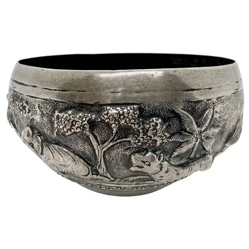 A small antique Indian silver bowl, decorated with an emboss...