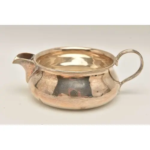 A GEORGE V SILVER JUG, fitted with a scroll handle, hallmark...