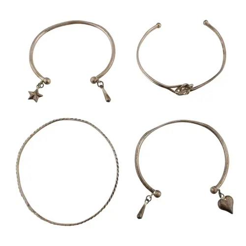 Collection of silver bangles and cuff bracelets. Four bracel...