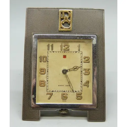 An Art Deco Le Coultre 8 day travel clock with silver frame,...