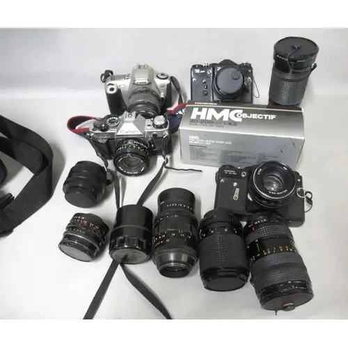 Canon AE-1 35mm camera, together with two Zenit 35mm cameras...