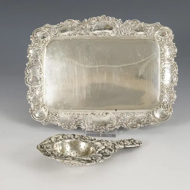 Small silver tray and tea strainer.