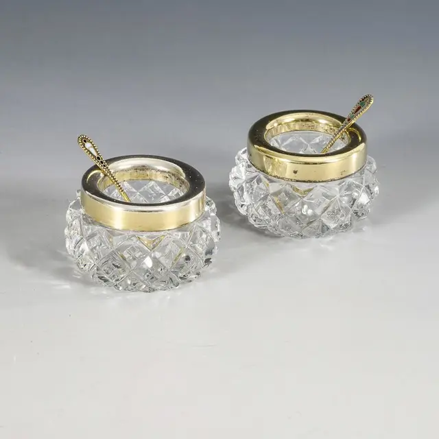 Pair of Russian salt shakers with small spoons.