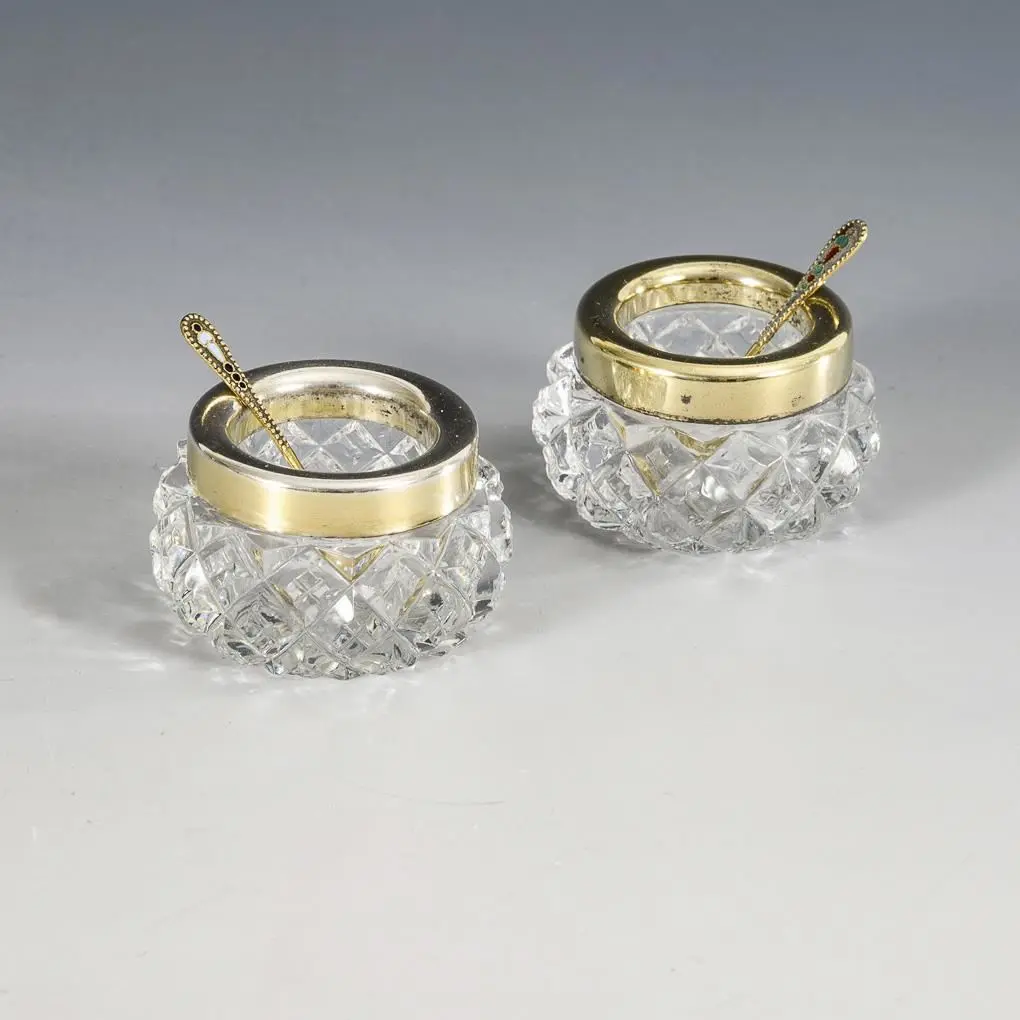 Pair of Russian salt shakers with small spoons.