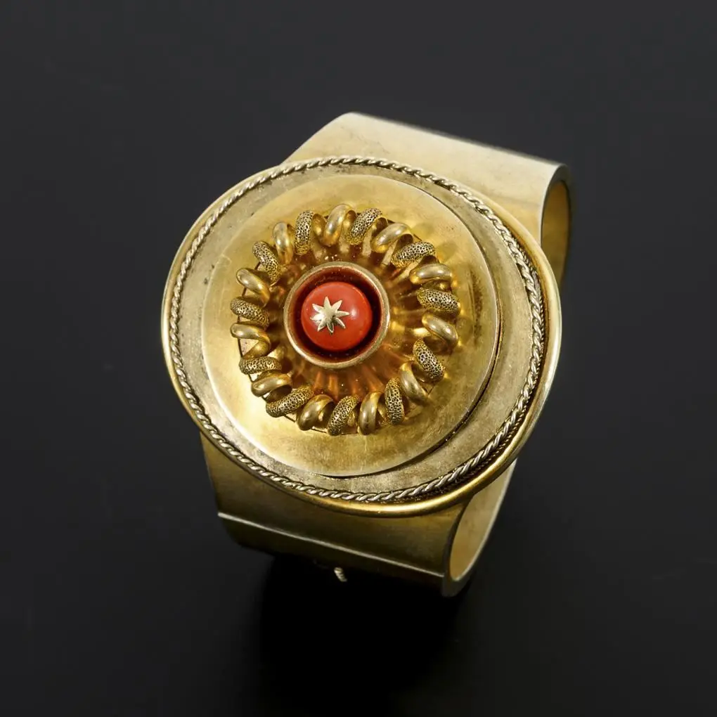 Historic bangle with a coral bead.