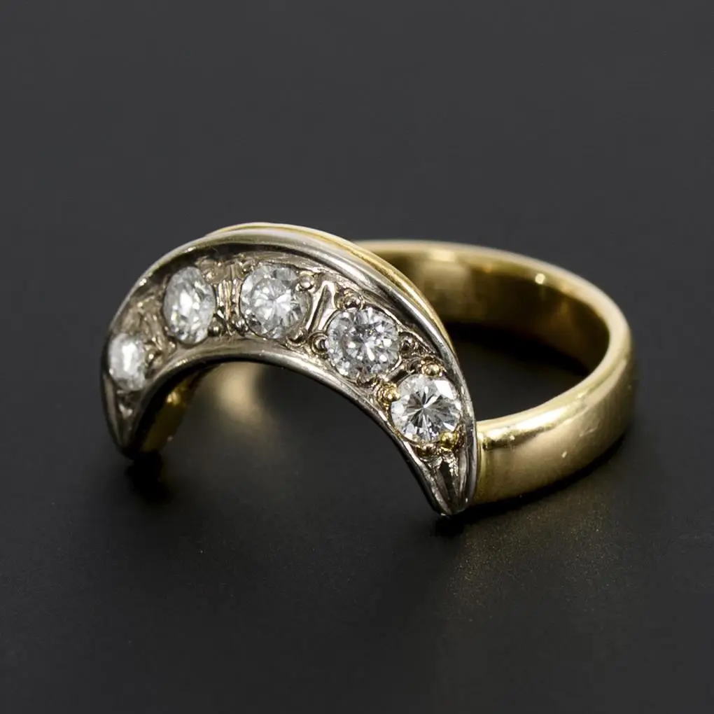 Crescent-shaped ring with old-cut diamonds.
