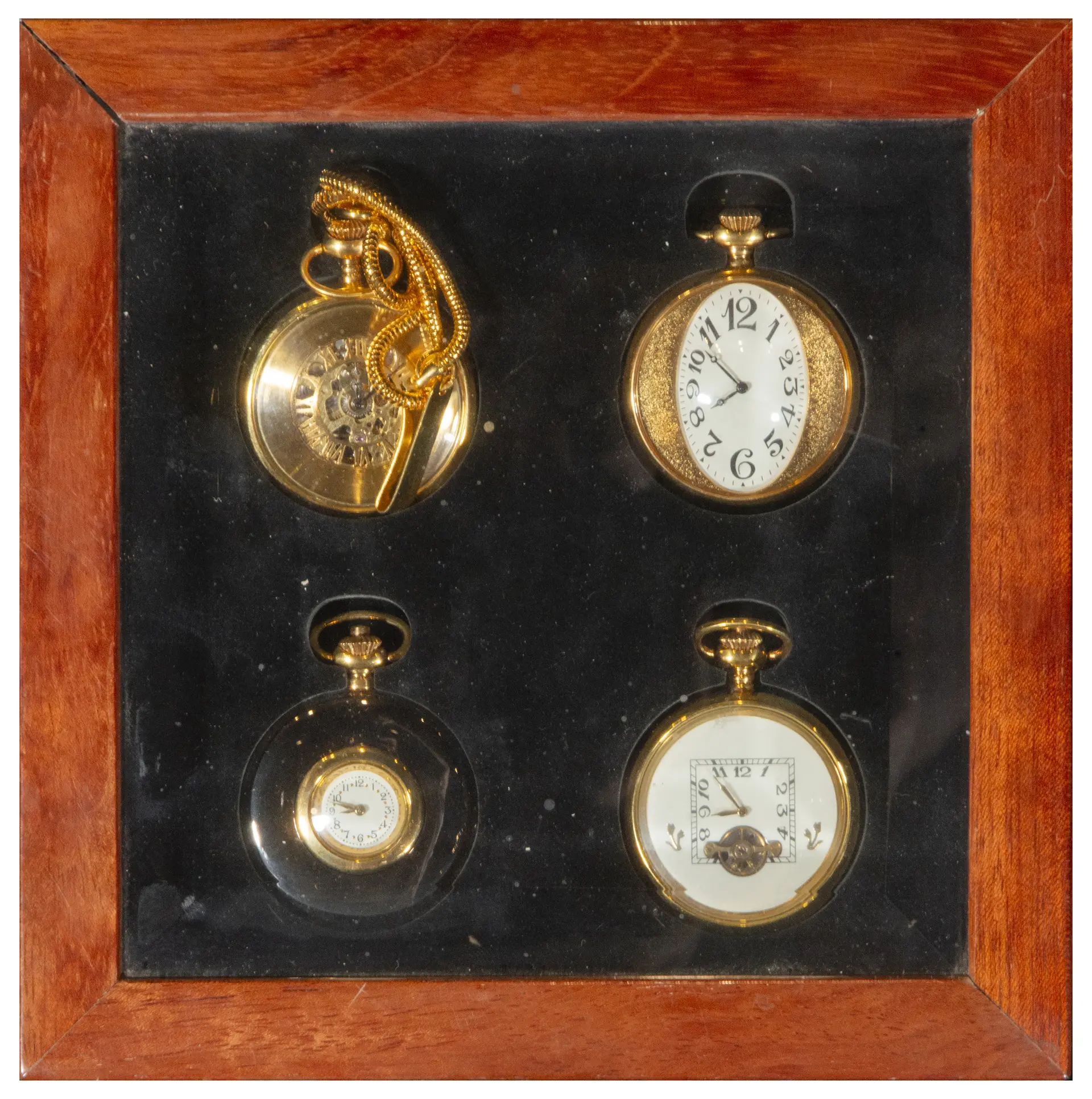 Set of four pocket watches in a wooden display case