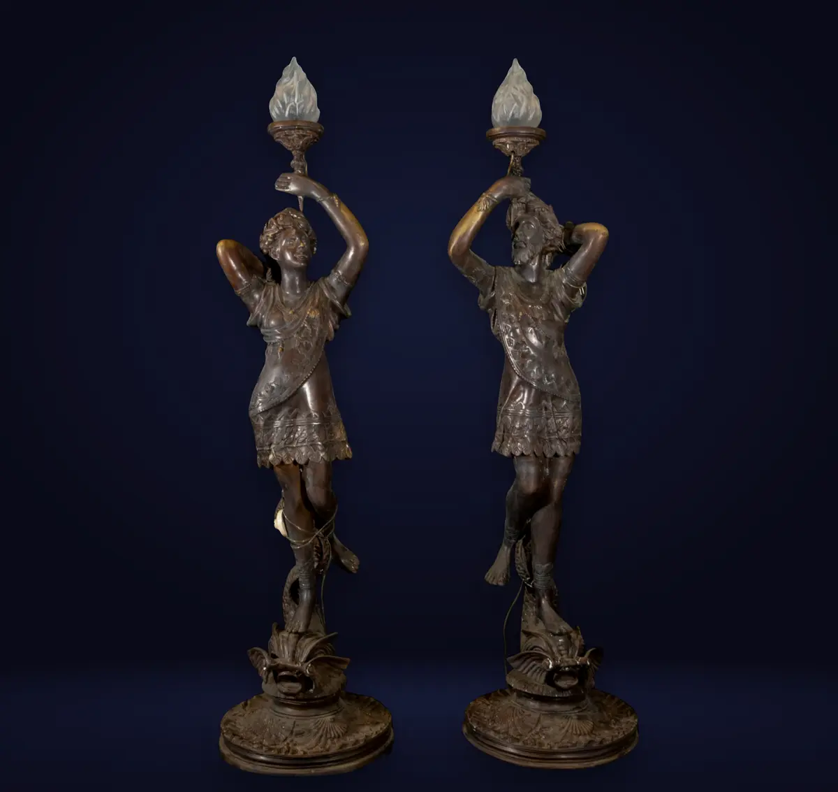 Pair of monumental Art Nouveau torch holders in patinated bronze