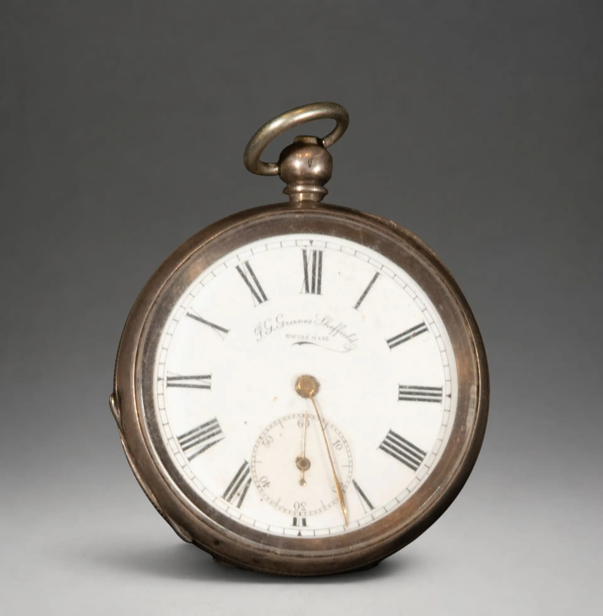 Pocket watch with engraved cover and white dial
