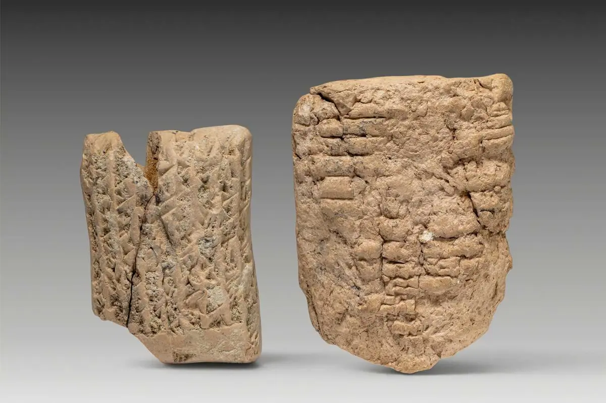 PAIR OF SUMERIAN CLAY TABLETS WITH CUNEIFORM INSCRIPTION