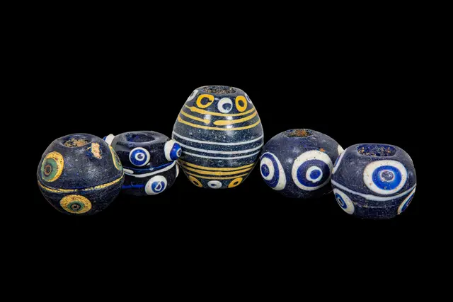 COLLECTION OF LARGE PHOENICIAN POLYCHROME GLASS EYE BEADS