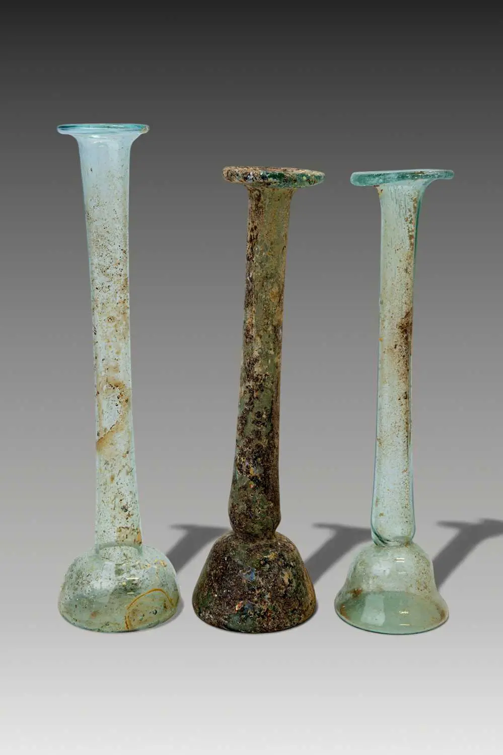 COLLECTION OF ROMAN GLASS TALL UNGUENTARIA
