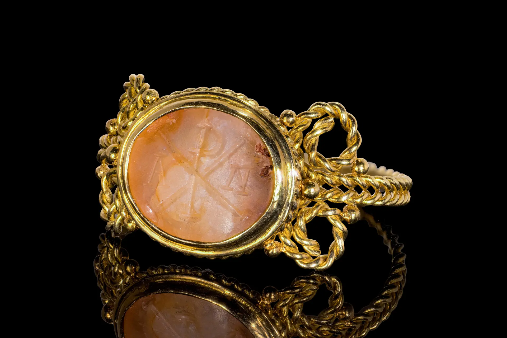 EARLY BYZANTINE PINK CHALCEDONY INTAGLIO WITH CHI-RHO MONOGRAM IN GOLD RING